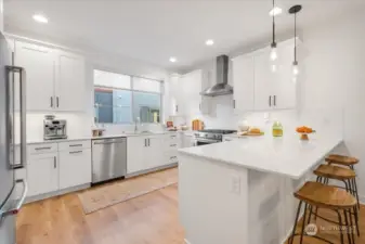 Huge kitchen with Quartz countertops and Stainless Steel appliances.