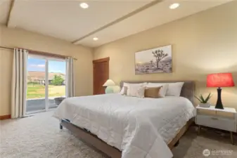 Lower level bedroom 4 w/ on-suite bath and glass sliding doors leading to the outdoor living area.