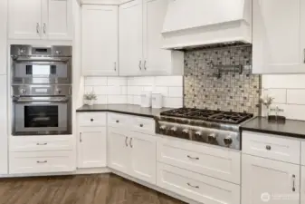 You'll notice the Subway tile that gives this kitchen a modern farmhouse feel accented with the beautiful stove backsplash that complement the pot filler centerpiece.  High-end Thermador appliances complete this kitchen offering even a steam oven used for hydrating food and helps prevent both drying and keeps flavors locked in. Who knew!
