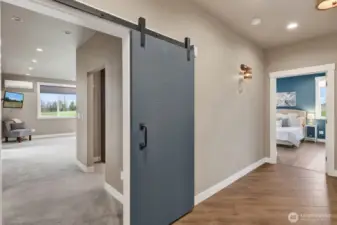 The large primary entrance welcomes you in with its barn door statement. Also highlighted here, you can really see how wide the hallways are specifically designed to accommodate ADA accessibility if needed.