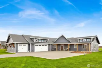 Front elevation shot picturing the 1,339 sq ft 3-car garage, RV or Trailer spot with hook-ups, and the zero step entry.