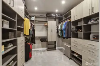 Wow! Check out the stunning custom-built storage found in this spacious primary walk-in closet designed to keep your whole wardrobe perfectly organized. With so much space, there's even enough room to add a center bench.