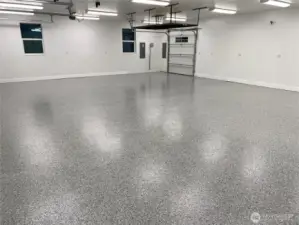 This 1,339 sq ft 3-car garage has all the room needed to store all of your cars, tools, and more! Seen in the back is the pull through door leading you to the exterior outdoor shed building.  And if that isn't enough, this garage even comes complete with BRAND NEW Epoxied floors!