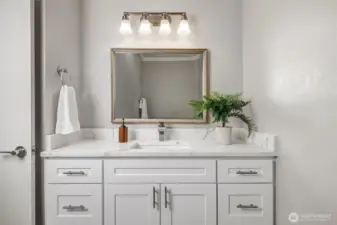 Secondary bathroom with brand new vanity and quartz counter top