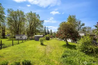 The expansive lot opens endless possibilities: plant your dream flower or vegetable garden, expand the current home, or even build a new home, garage, or shop in the back.