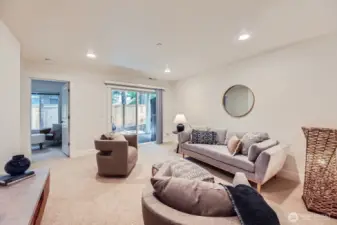 Lower level media room / bonus room. Great for watching movies, playing games and hanging out. Slider leads to covered patio, small yard and storage shed.