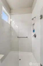 Large, fully tiled shower in primary