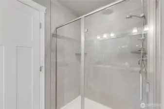 Primary: large glass enclosed shower.