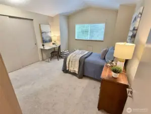 second bedroom upstairs has cathedral ceiling, good sized closet and peaceful outlook to wooded area