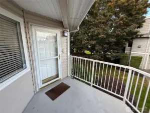 Covered entry deck has room to set a couple chairs out and enjoy the setting