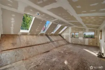 Large bonus room that was in the middle of being remodeled but now a blank canvas for you personal needs.  Windows in the backgound looking west towards the islands and bay.