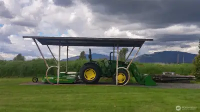 This cover currently has a trailer parked under it but was used in the past for their tractor.