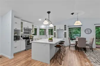 Large island, quartz countertops, and bar seating.