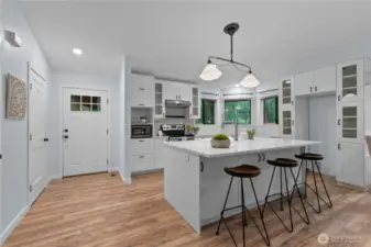 Stainless steel range, tile backsplash, and built-in cabinetry