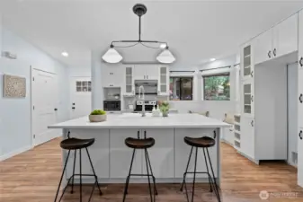 Spacious kitchen island with pendant lighting and seating