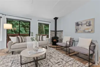 Living room with wood stove and access to deck