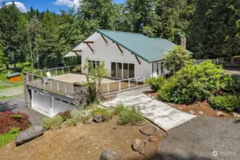 Large Veranda off the entrance captures beautiful views of the property