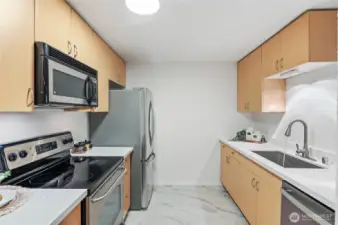 The kitchen has been refreshed with a new countertop, modern faucet, stylish sink, and brand-new flooring—creating a clean and inviting space to cook and gather