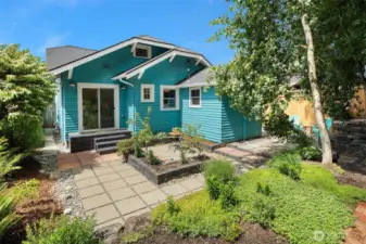 Sunny outdoor space with patio and mature landscaping