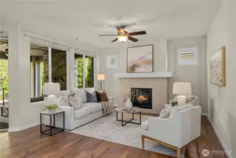 The spacious great room offers a sleek, tiled fireplace and huge picture windows overlooking the breathtaking back yard. Shutters in the windows above the fireplace and top down/bottom up in the large windows.