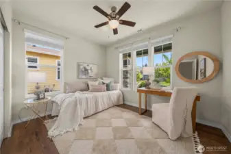 Spacious second bedroom overlooks the wide front porch.  Ceiling fan and blinds.