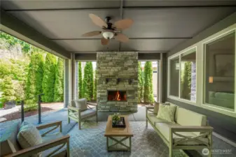 The stunning stone fireplace creates a lovely and inviting ambiance while overlooking the private and delightful backyard.