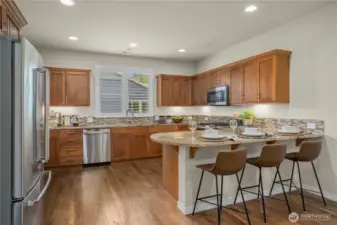Gorgeous kitchen boasts of gorgeous granite counters, classic cherry cabinets, shutters encase the window over the kitche sink where you will delight with the amazing sunsets!