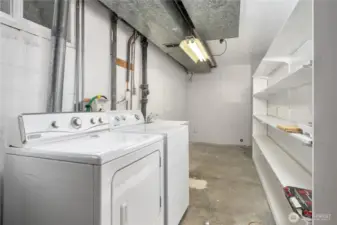Large utility room with plenty of storage space is located at the bottom of the stairs.