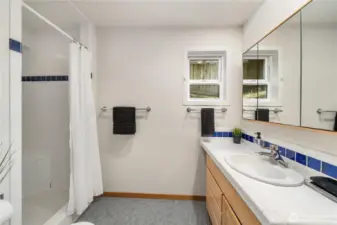 3/4 bath located at the end of the hallway complete with tiled shower and large mirrored medicine cabinet.