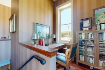 Tucked beside the stairwell, this charming workspace offers a quiet spot to write, read, or simply enjoy the view of the hills.