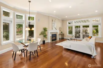 Dream kitchen boasts high-end appliances, including a Bosch refrigerator and dishwasher. Features include a stylish tiled backsplash, glass pantry door, spacious central island with cabinetry, slab granite countertops, and an elegant breakfast nook that flows from the family room to the outdoor retreat. Abundant natural light completes the space.