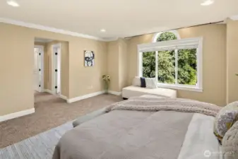 Master suite with spa bath features an extra-large jetted tub and tiled  shower, heated travertine floor, two skylights, two walk-in closets, and soothing territorial views through picture windows.