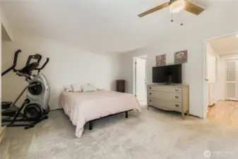 Large primary bedroom with newer carpet, dual closets and attached full bathroom.