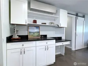 Mini-split for heat/AC. Door leads to primary bedroom and utility room.