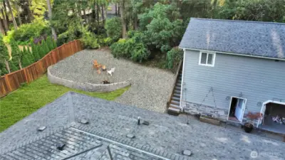 Versatile back yard for garden area, fire-pit/entertaining, play area. Stair up lead to studio apartment.