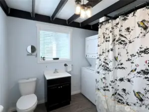 Comfortably sized bathroom with laundry