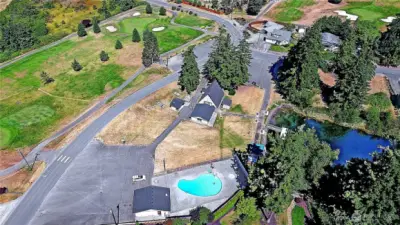 Aerial view of the community chalet, fishing dock and one of two community pools.