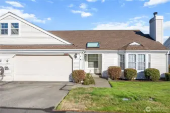 A duplex style condo with fenced yard & 2 car garage