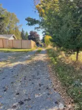 Long access road leads to this and one other property through gate