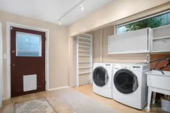 There's a laundry area on the lower level by a backdoor that goes out to the backyard patio.