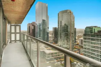 There are sliding glass doors leading out to the deck off both the living room and the bedroom. You can see both the Olympic mountain range and the Cascade Mountain Range.