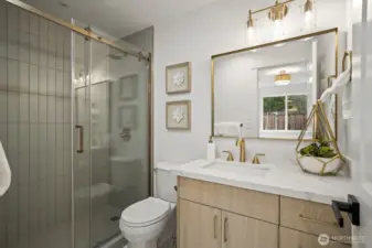 Fully renovated primary bathroom with elegant tiled shower