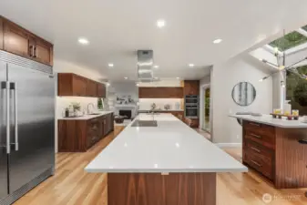 The CHEF’S KITCHEN features abundant cabinetry, a 10+ ft quartz island