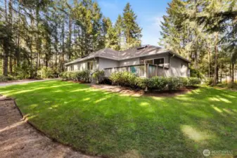 Lot is fully landscaped and has mature plantings that are low care. Rhodies, azaleas, & more plus a ring of trees for privacy.