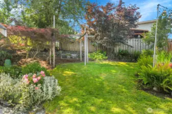 It's a little slice of paradise in the back. Lots of flowers. A little green grass. It's a perfect spot to relax.