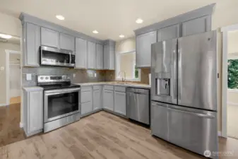 Kitchen with stainless steel appliances, and new floors