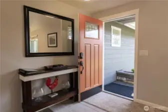 Entry with a beautiful vibrant orange front door