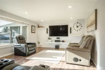 Main living room, hard wood floors and beautiful shiplap wall with built in shelves