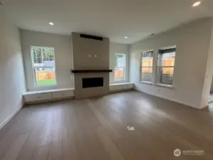 Beautiful great room with natural light, tiled fireplace and built in cabinets