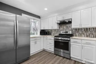 Beautiful backsplash with stainless steel appliances and gas range